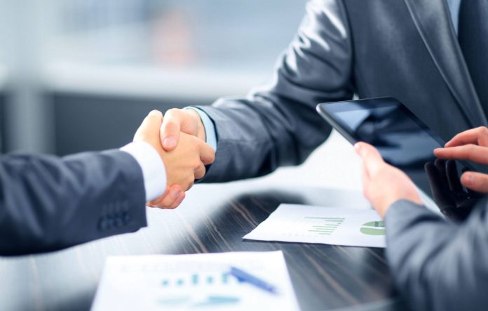 Business people shaking hands in office unlocking-business-potential-premier-consultants-comprehensive-registration-services