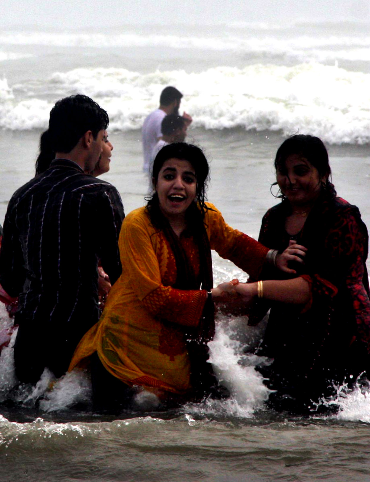 Visitors Enjoying Sea Waves At Sea View During Pleasant Weather
