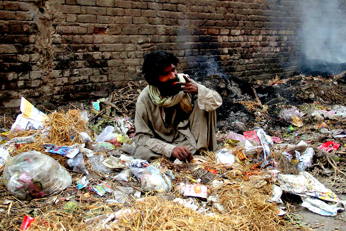 A Man Seen Eating Discarded Rotten Fruits At Garbage