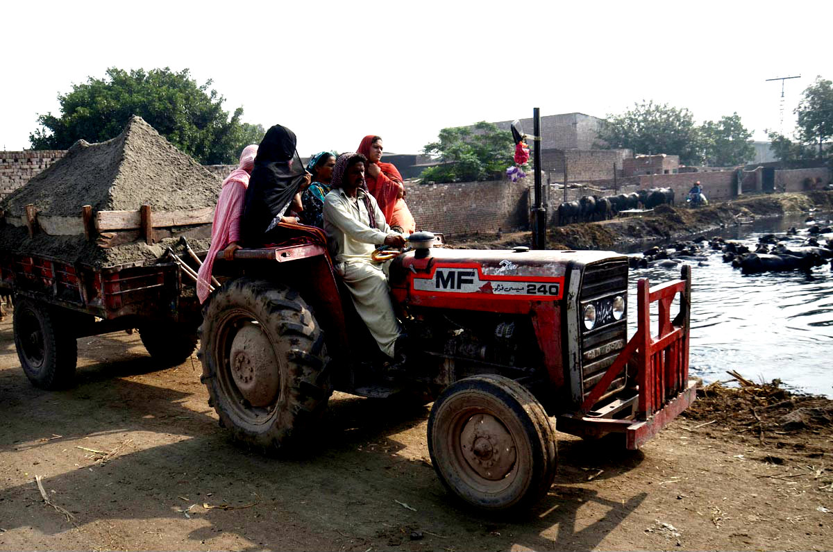 Women Workers Seen Travelling On Traditional Tractor Trolley