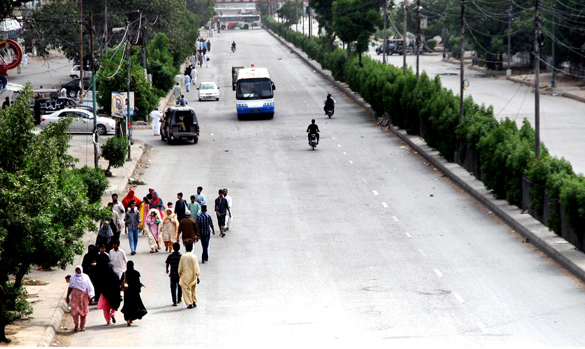 People Walk on Road Due To Non Availability Of Transportation