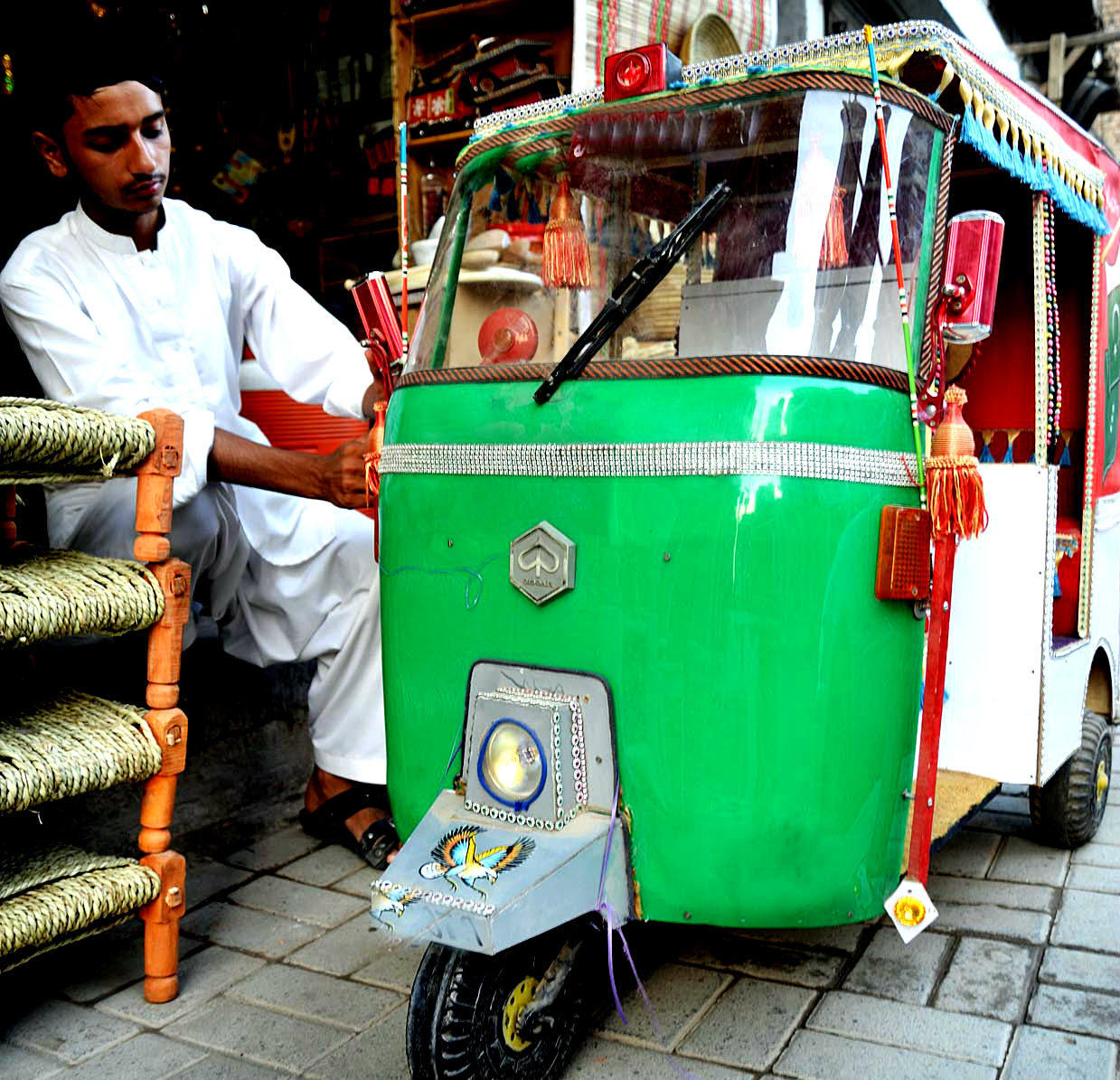 A Young Artisan Seen Giving Final Touches To A Model Of Auto Rickshaw