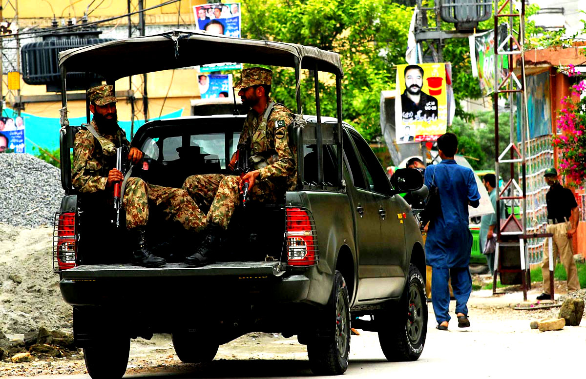 Army Personnel Patrolling Near A Polling Station During AJK elections